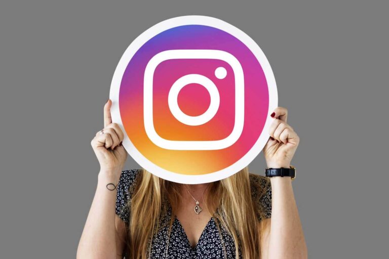 Woman holding the Instagram logo, illustrating social content and advertising
