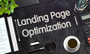 Landing page optimization planning desk with notes, calculator and laptop