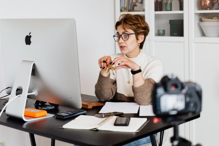 Woman recording a presentation at a desktop computer for an online session