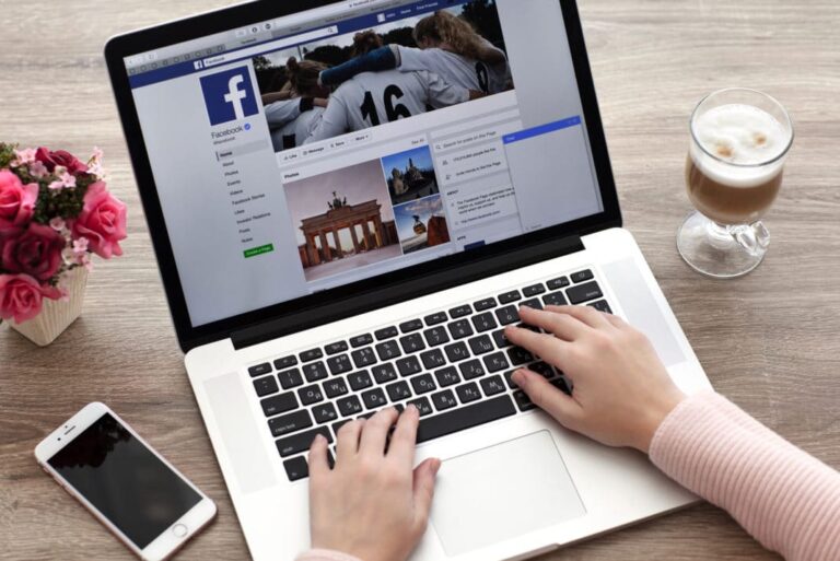 Person working on Facebook content on a laptop for ad creative development