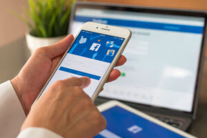 Facebook on a smartphone and laptop illustrating audience discovery